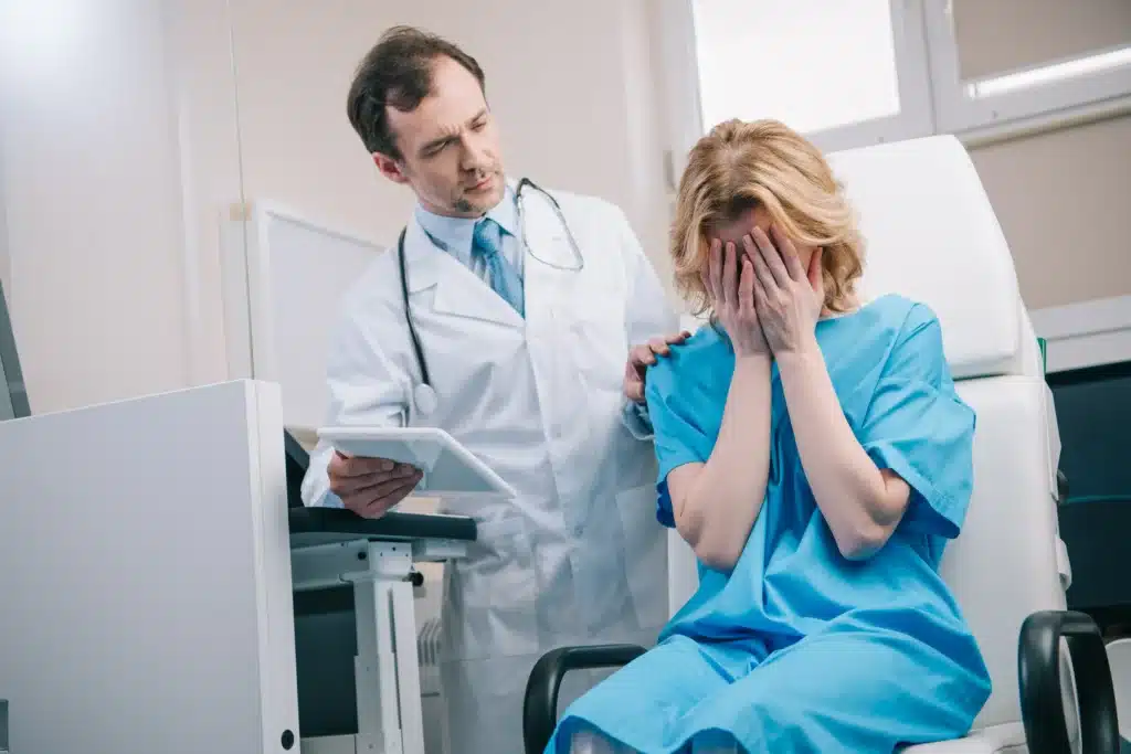 a doctor consoling a crying female patient