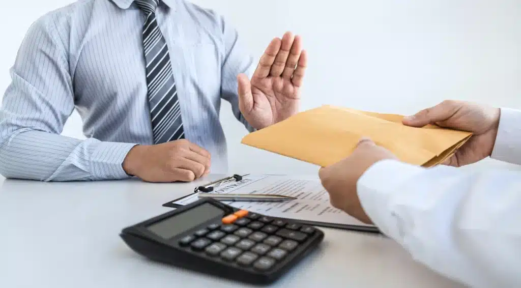 A man rejecting cash in an envelope