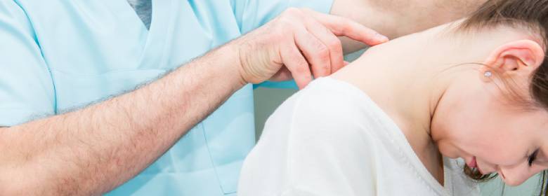 Doctor checks spine of injured patient