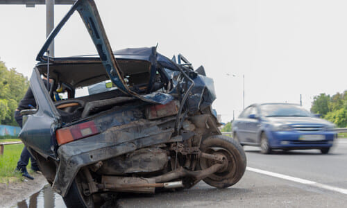 A hatchback with a totaled rear-end after a collision with an uninsured motorist.