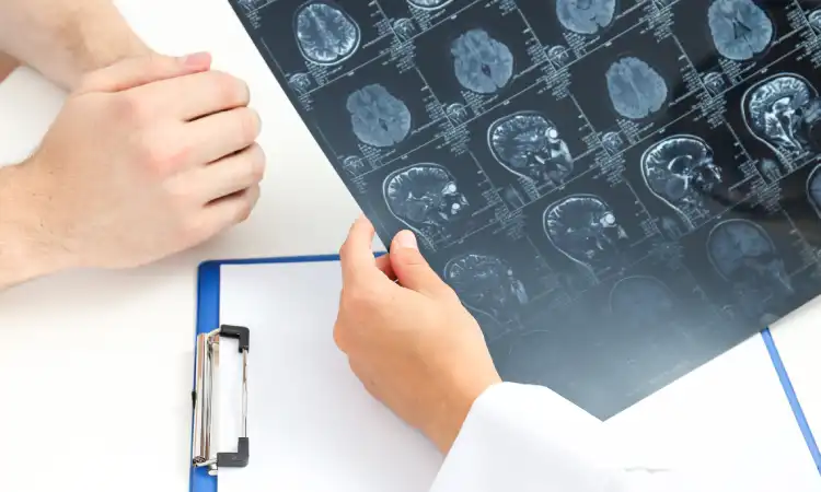 A doctor going over the results of a patient's brain scan with them in a clinic.