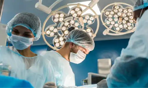 Hospital staff preparing an operating theater for a patient's upcoming surgery.