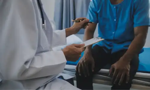 A patient getting diagnosed at a doctor's clinic in a hospital building.