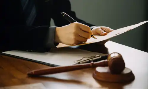 A personal injury lawyer holding an envelope containing a client's settlement for a retained placenta.