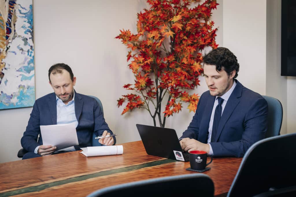 Two Olson lawyers working on a computer