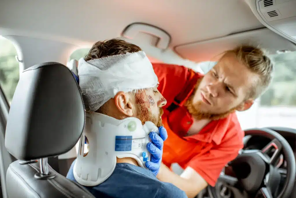 A paramedic helping an accident victim dress his head injury