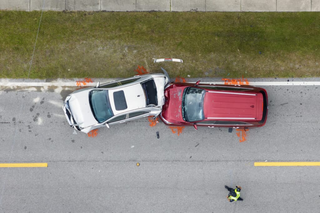 Car crash with two vehicles collided at traffic accident site on American street.