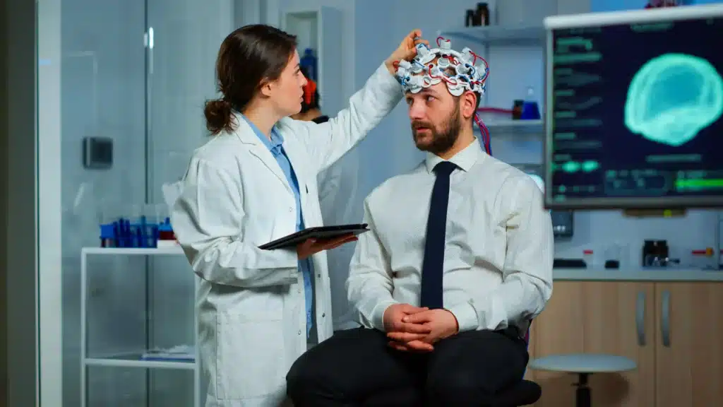 A doctor testing the something in a man's head