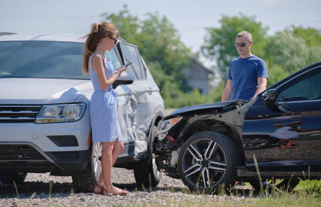 Two drivers having argument over who is guilty in car crash accident. Road safety and insurance concept.