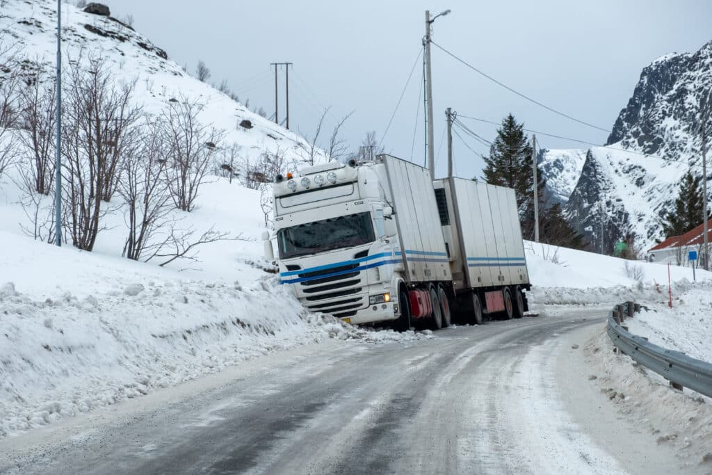 Trailer truck accident slippery on snow pavement in countryside