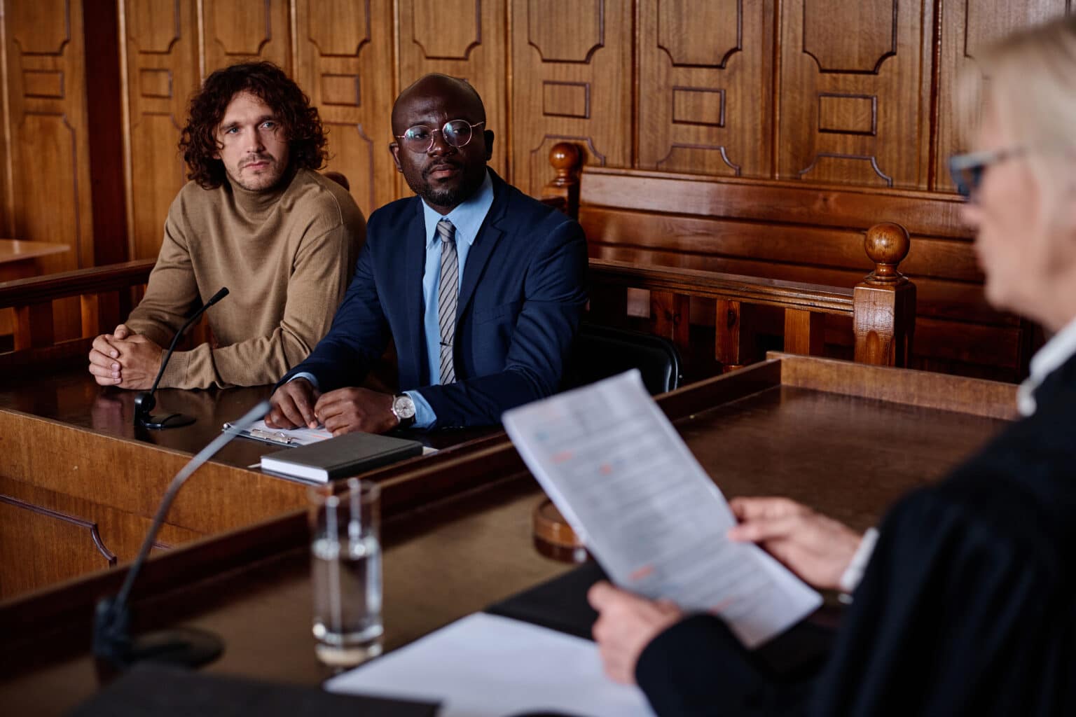 attorney and client looking at female judge