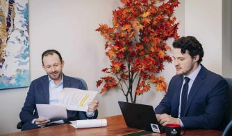 attorney phillip meinkoth and coo rob buick reviewing documents together