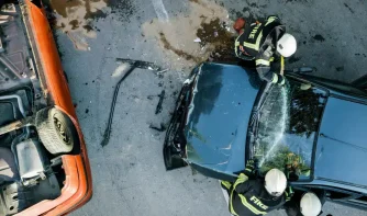 Firefighters putting out a car on fire