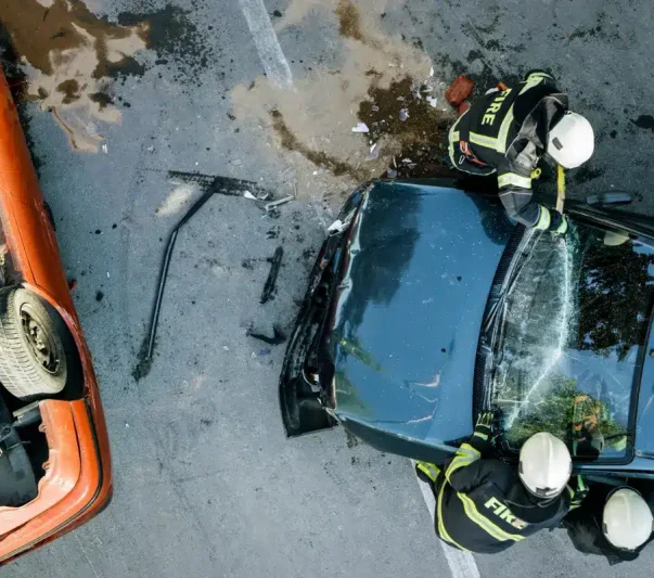 Firefighters putting out a car on fire