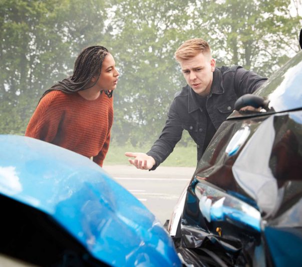 two angry motorists arguing over responsibility for car accidents