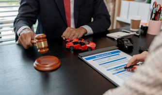 a lawyer is explaining the details of a car insurance policy to the car owner before she signs it,