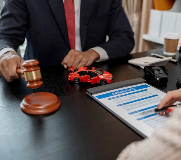 a lawyer is explaining the details of a car insurance policy to the car owner before she signs it,