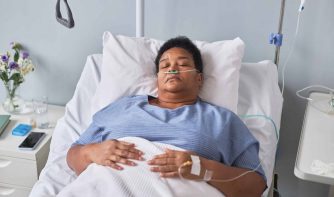 senior woman laying on hospital bed
