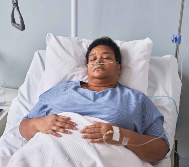 senior woman laying on hospital bed