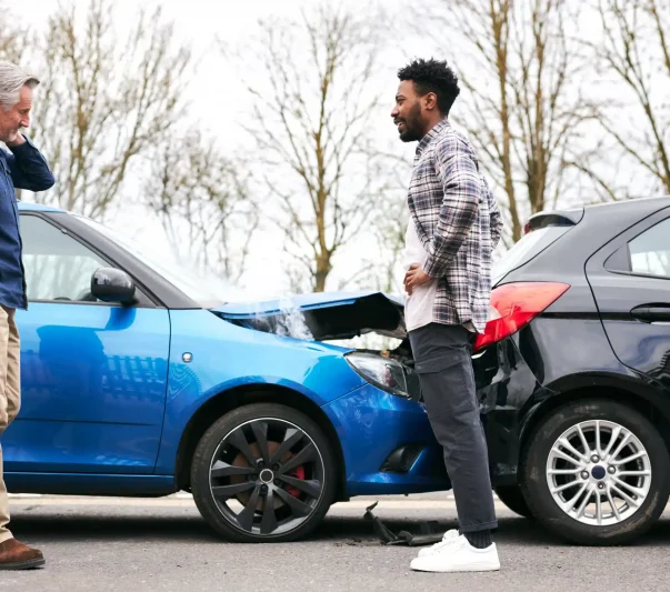 Two men discussing after a rear end accident