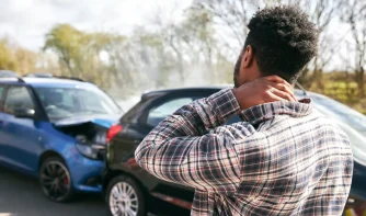 A man holding his neck after a rear end accident