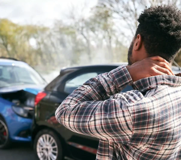 A man holding his neck after a rear end accident