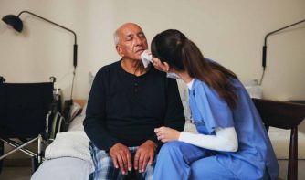 nurse helping nursing home resident