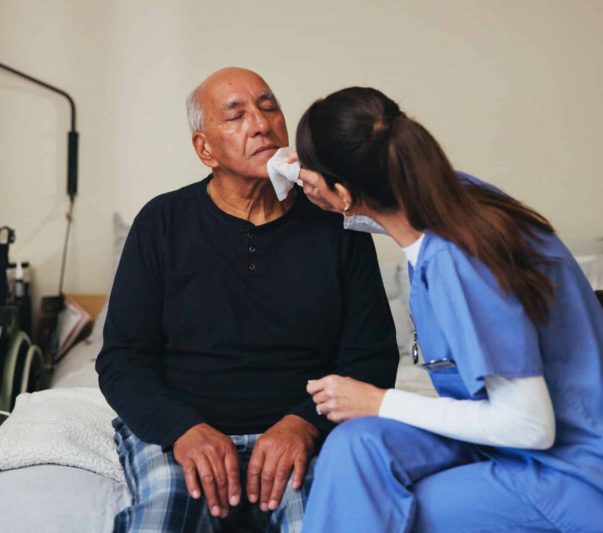 nurse helping nursing home resident