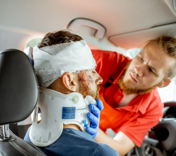 A paramedic helping an accident victim dress his head injury