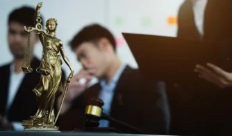 A group of attorneys and a justice symbol on the table