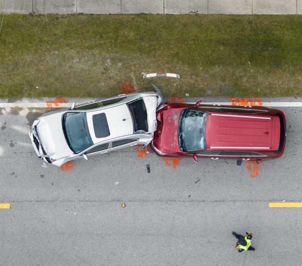 Car crash with two vehicles collided at traffic accident site on American street.