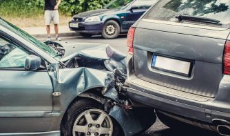 Close up smashed cars on a road.