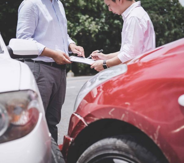 Insurance Agent examine Damaged Car and customer filing signature on Report Claim Form process after accident, Traffic Accident and insurance concept.