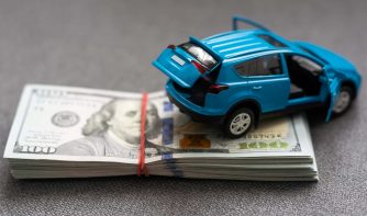 car and money. concept of car, Rent, car insurance, Toy car and money over white