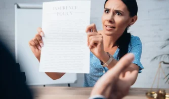 A lady showing an attorney a document saying insurance policy