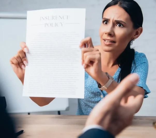 A lady showing an attorney a document saying insurance policy