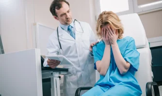 a doctor consoling a crying female patient