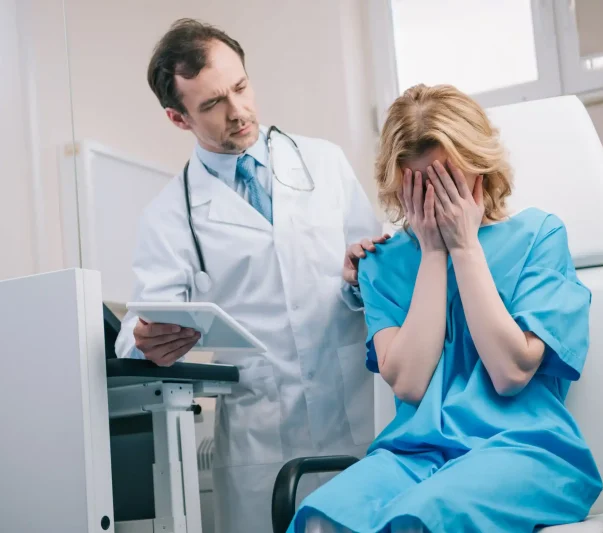 a doctor consoling a crying female patient