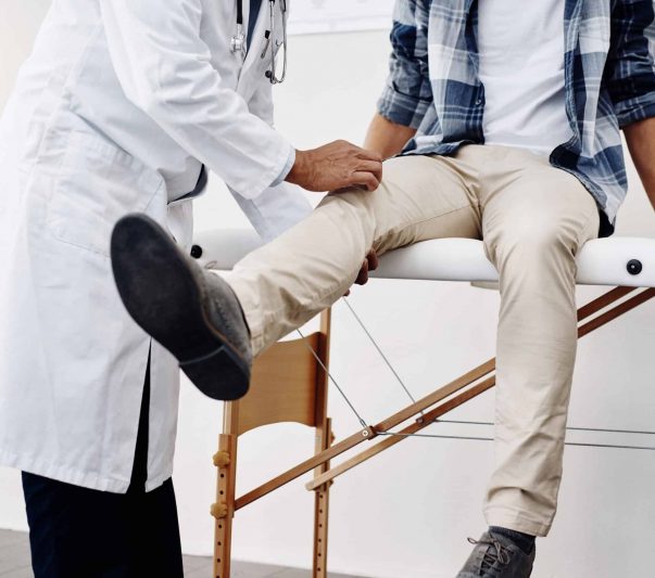 A doctor examining a patient's knee