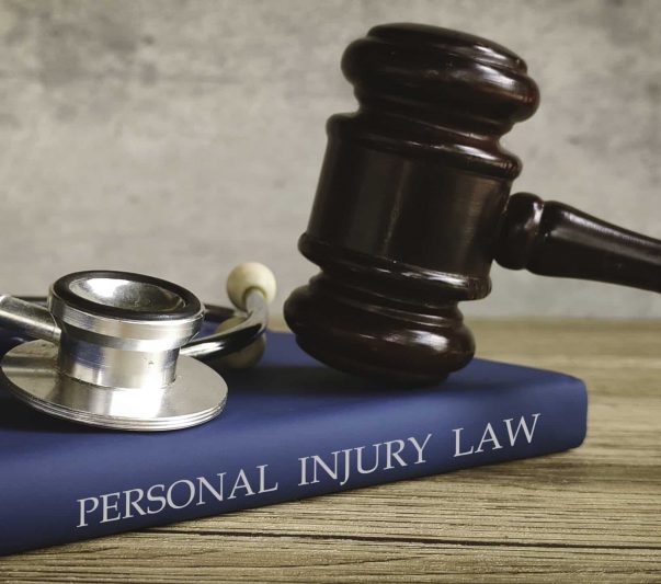 Gavel and stethoscope on a book titled "PERSONAL INJURY LAW," symbolizing legal action for medical issues.