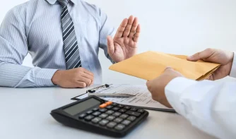 A man rejecting cash in an envelope