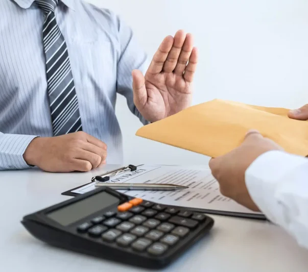 A man rejecting cash in an envelope