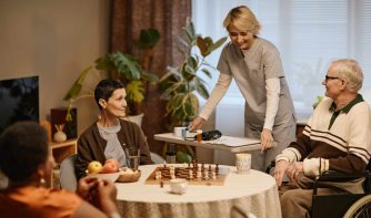 nurse interacting with patients at nursing home
