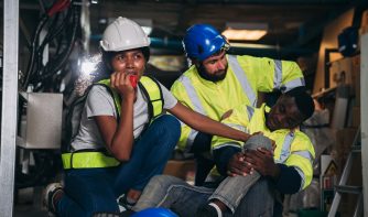 Team Engineers calls for assistance after a team member sustains a leg injury while doing electrical work. Technician in inverter solar panel room.