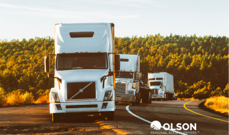 three white trucks at the side of the road