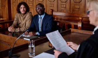 attorney and client looking at female judge
