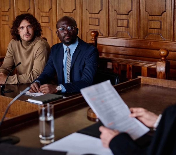 attorney and client looking at female judge