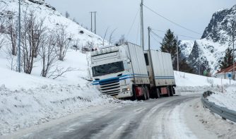 Trailer truck accident slippery on snow pavement in countryside